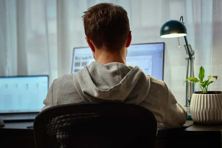 man-working-from-home-at-desk-with-computer-and-la-2025-08-24-22-07-21-utc (1)